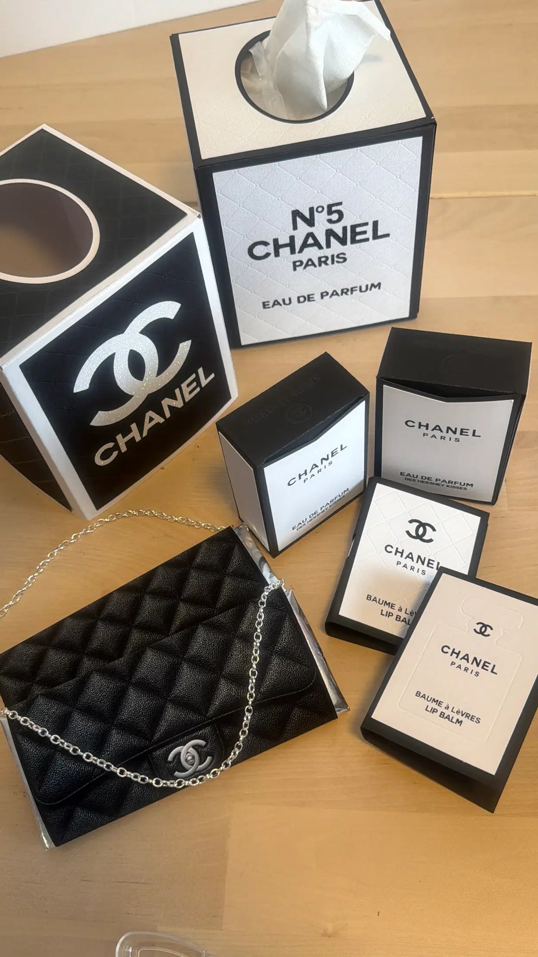 A black quilted designer-inspired paper candy purse with a silver chain handle and a pocket for a gift card